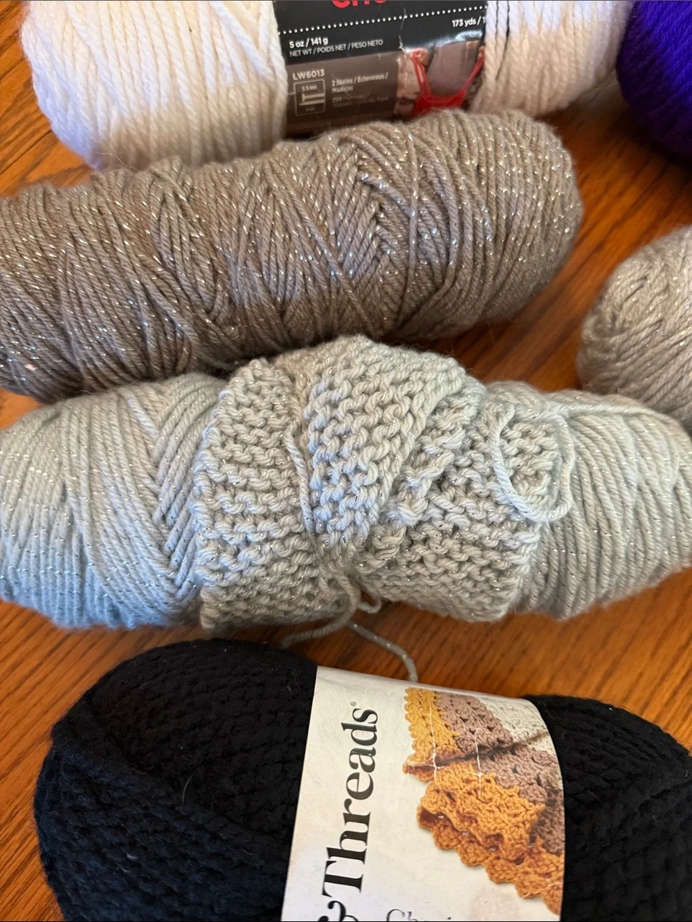 Super Saver Yarn Bundle in Purple, Black, white, gray metallic, and brown.